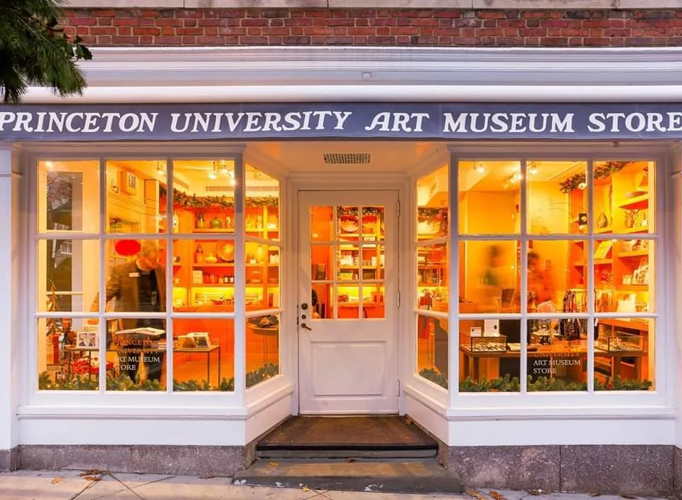The lit windows of the Princeton University Art Museum Store at night