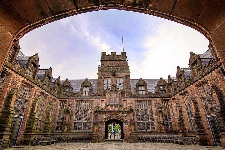 A stone courtyard framed by a gothic arch