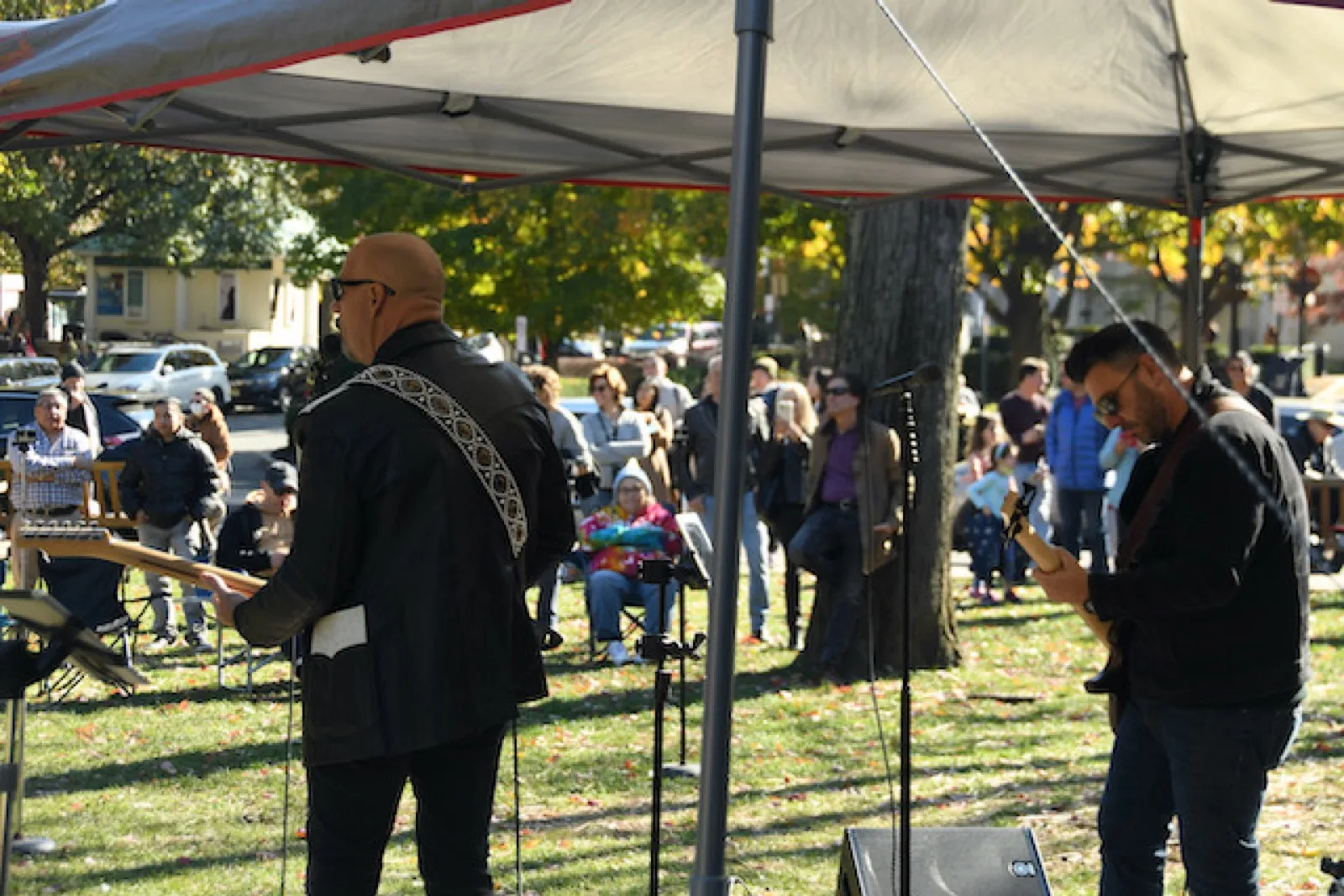 A band playing live to an outdoor crowd on the green