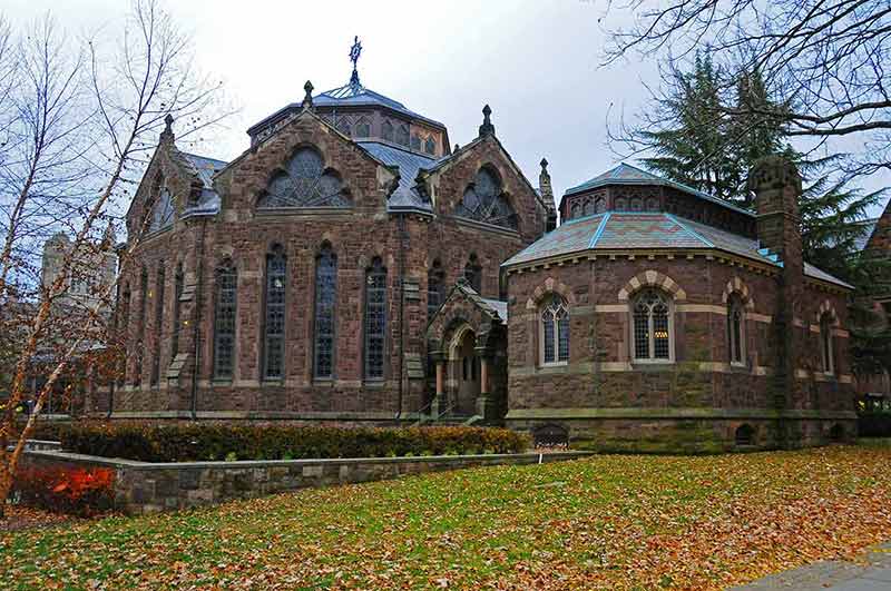 A brownstone Gothic chapel among fallen autumn leaves