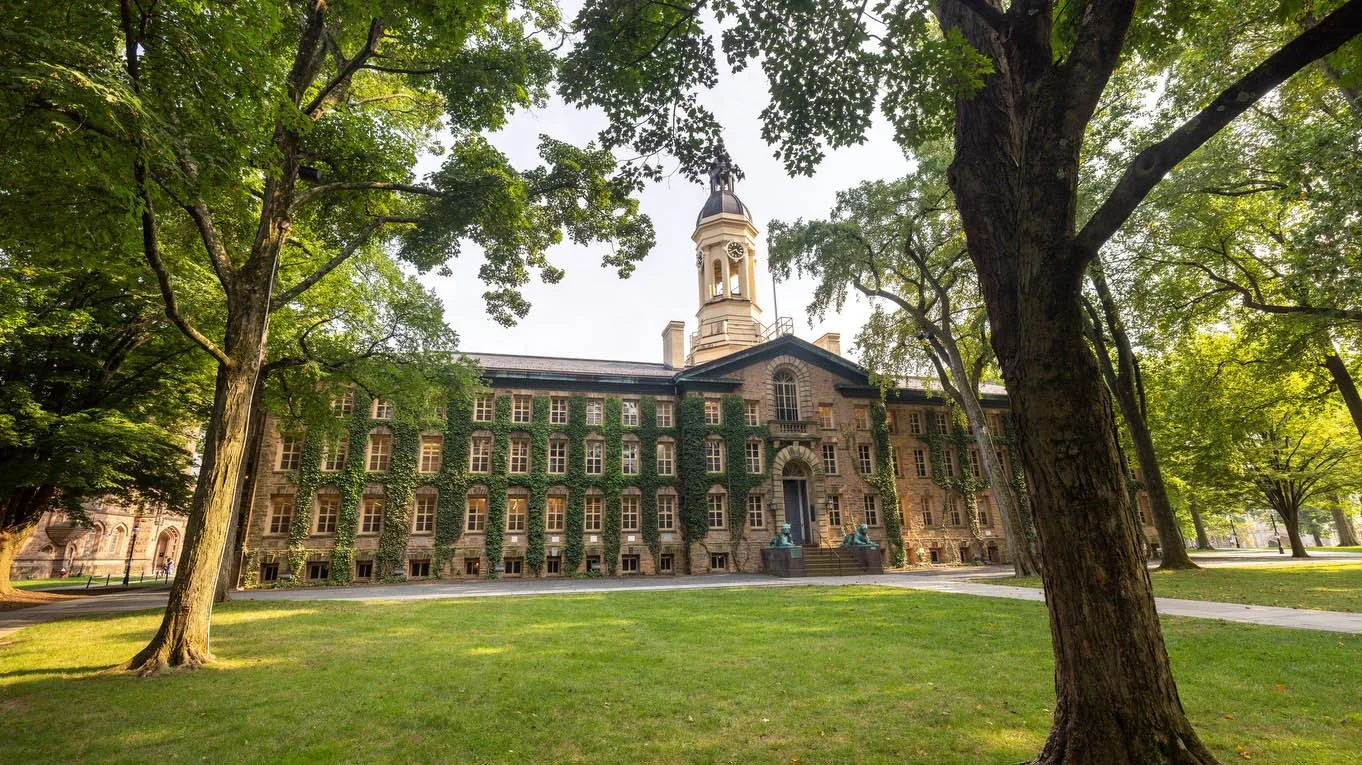 Ivy-covered Nassau Hall framed by trees