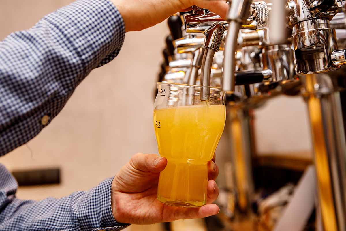 A glass being poured at a bar tap
