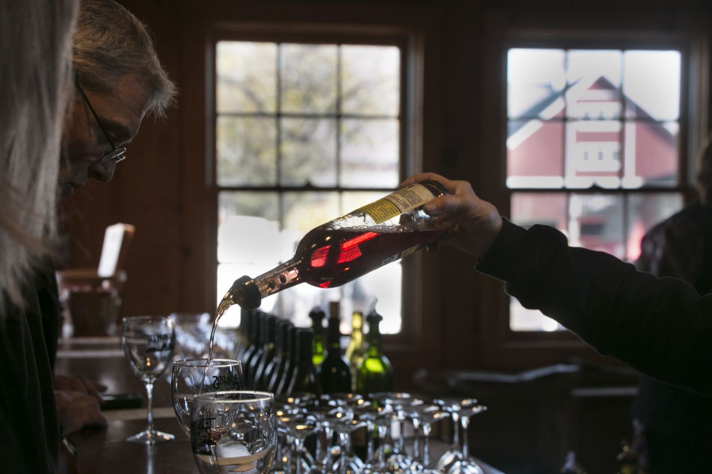 Wine being poured at a tasting counter